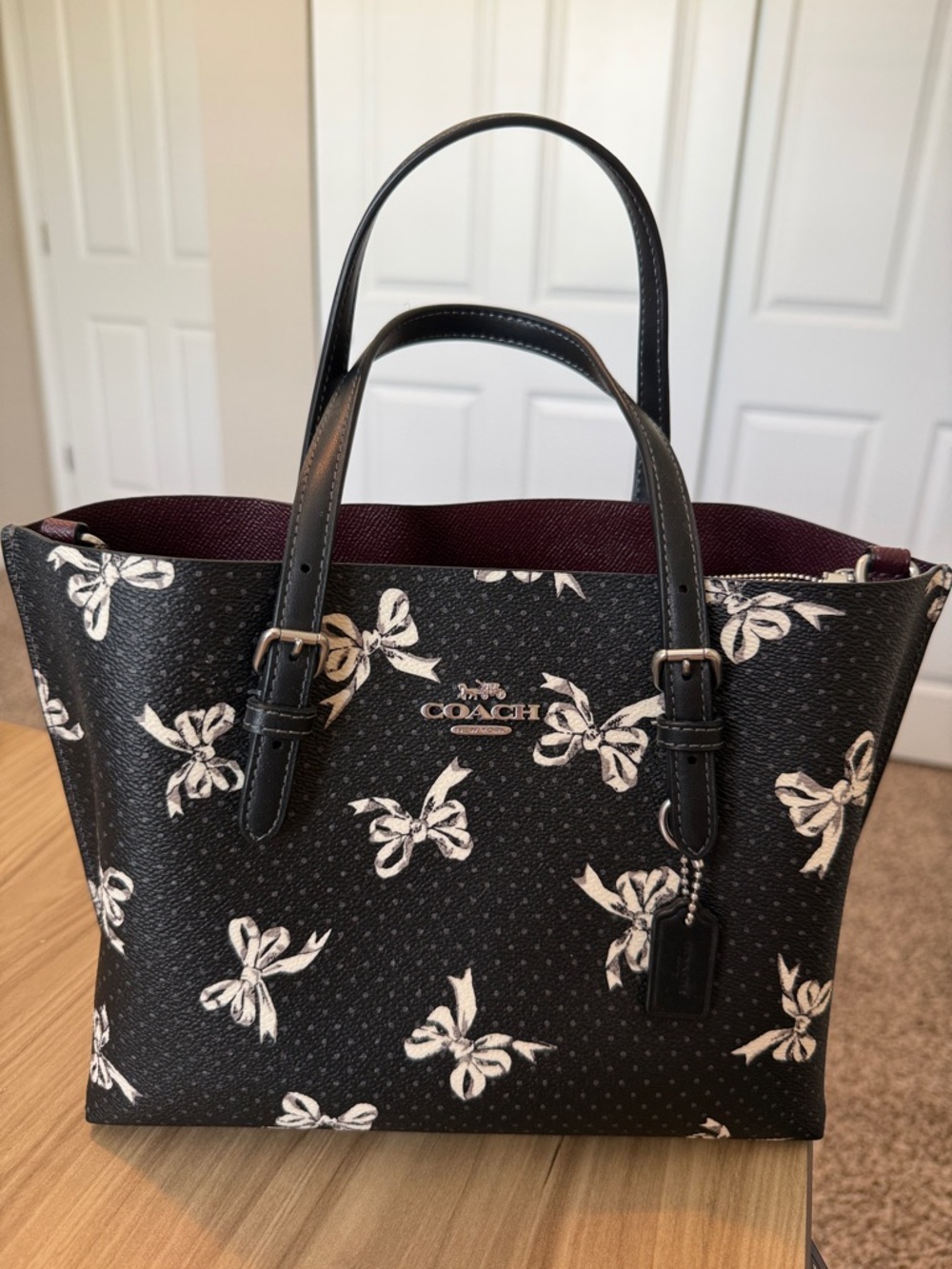 Coach Black Bow Print Tote with Burgundy Interior Accents